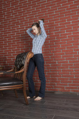 Young woman straightens her hair