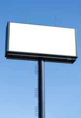 Blank billboard ready for new advertisement and blue sky.