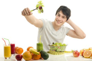 Happy man having a table full of organic food,juices,smoothie