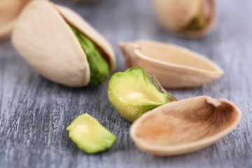 Pistachio nuts on wooden background