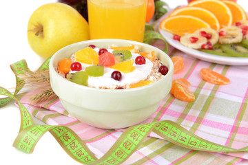 Delicious oatmeal with fruit in bowl on table close-up