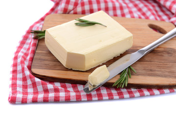 Tasty butter on wooden cutting board, isolated on white