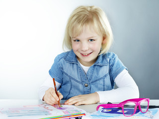 Cute blond child is proud to start at school