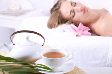 Beautiful young woman having relax in spa salon