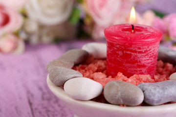 Composition with spa stones, candle  and flowers