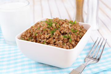 Boiled buckwheat in bowl on table close-up