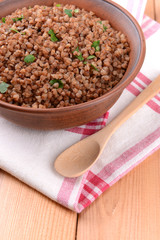 Boiled buckwheat in bowl on table close-up