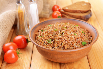 Boiled buckwheat in bowl on table close-up