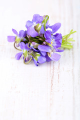 Violets flowers on wooden table