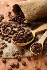 Coffee beans in sack on table close-up