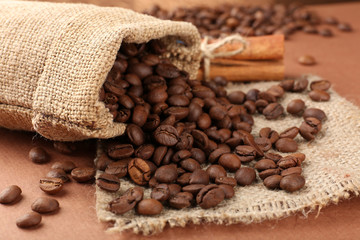 Coffee beans in sack on table close-up
