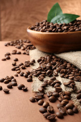 Coffee beans on table on brown background