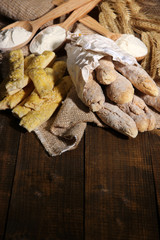 Fototapeta premium Bread sticks on sackcloth on wooden background