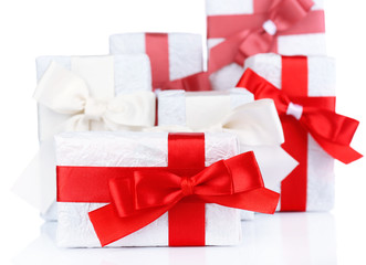 Beautiful gifts with red ribbons, isolated on white