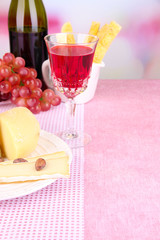 Assorted cheese plate , grape and wine glass