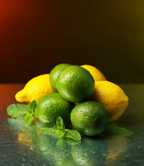 Lemons and limes on bright background