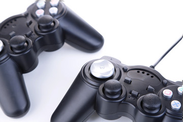 Black game controllers isolated on white