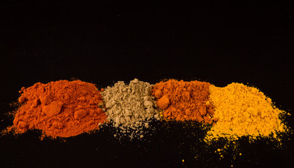 Mix powdered spices on black background