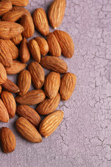 Almonds on color wooden background