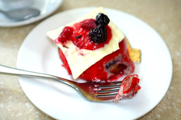 Tasty cake with berries on table in cafe