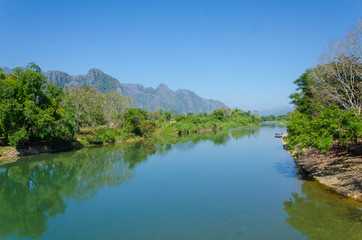 Fototapeta na wymiar Serene landscape by the Nam Song River at Vang Vieng, Laos