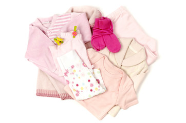 Close up with a pink stack of clean baby clothes isolated