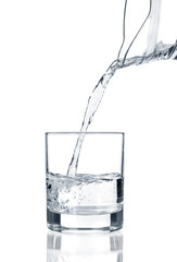 water pouring in glass isolated on white background