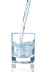 water pouring in glass isolated on white background