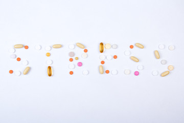 stress word text made of colorful tablets, pills and capsules