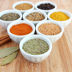 Spices in white bowls – Rosemary in the foreground