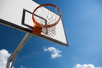 Basketball hoop against  lovely blue summer sky