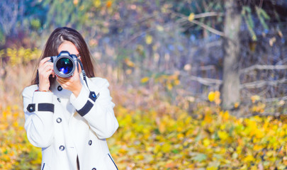 young woman using her camera to take photo