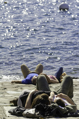 Lecco lake-Springtime tourists sunbathing color image