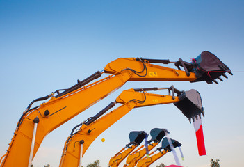 Excavator new bucket against the claear sky background