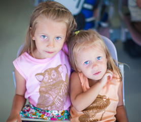 Portrait of two little beautiful blue-eyed girls