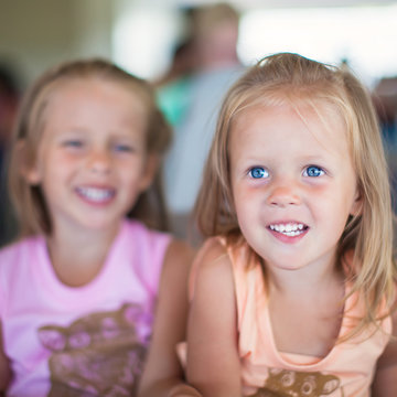 Portrait of two little beautiful blue-eyed girls