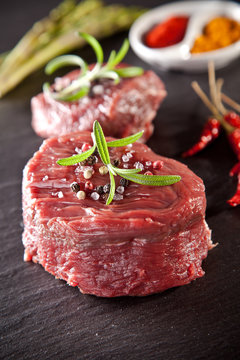 Fresh raw beef steak on black stone