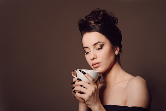 beautiful young girl with the cup of coffee