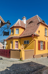 Fototapeta na wymiar Colorfull Medieval street in Sighisoara, Romania