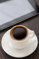 Fototapeta na wymiar Cup of coffee and tablet