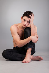 Fototapeta na wymiar Healthy muscular young man on grey background