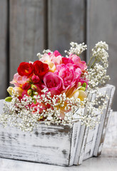 Bouquet of colorful freesia flowers in wooden shabby chic box