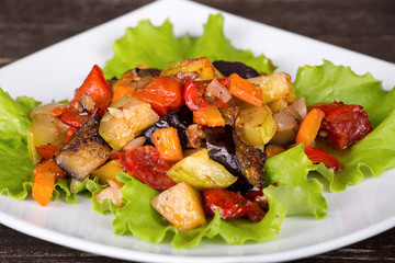 Roasted vegetables on a white plate, close up