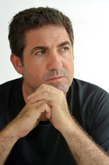 Mature man thinking with hands on chin looking away