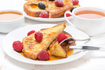 breakfast - french toast with raspberries and maple syrup