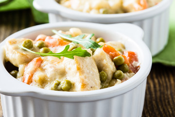 Chicken stew with carrrot and green peas in a creamy sauce