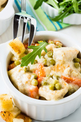Chicken stew with carrrot and green peas in a creamy sauce