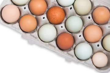 Assortment of fresh chicken eggs in tray, isolated