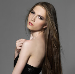 Naklejka premium Sensual young woman with beautiful long brown hairs