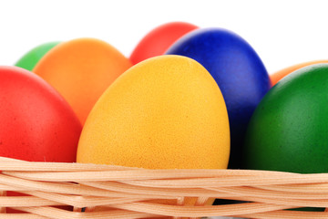 Colorful Easter eggs in basket.